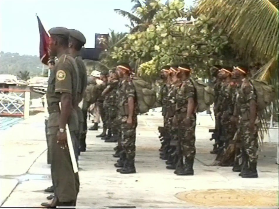 A group of Soldiers parading and practising their drills in front of their commanders on the waterfront in San Andrés.
